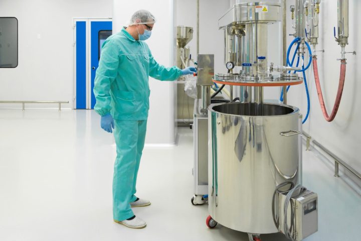 pharmaceutical-factory-man-worker-protective-clothing-working-with-control-panel-sterile-working-condition