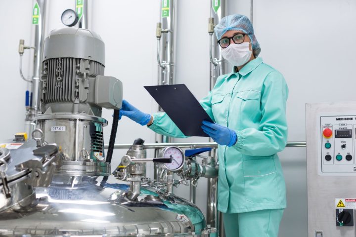 scientist-blue-lab-uniform-stand-near-big-pressure-tank-hold-tablet-look-camera